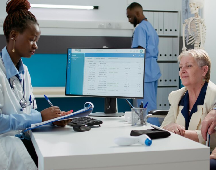 lady doctor noting info from patient