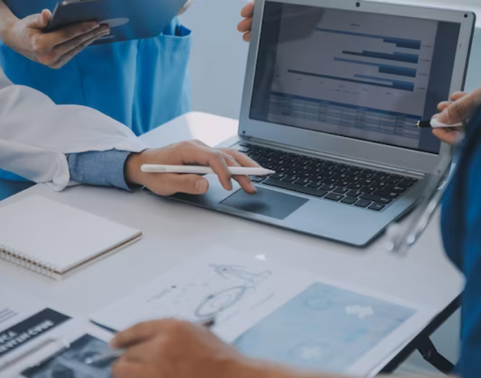 hospital staff discussing bills on laptop